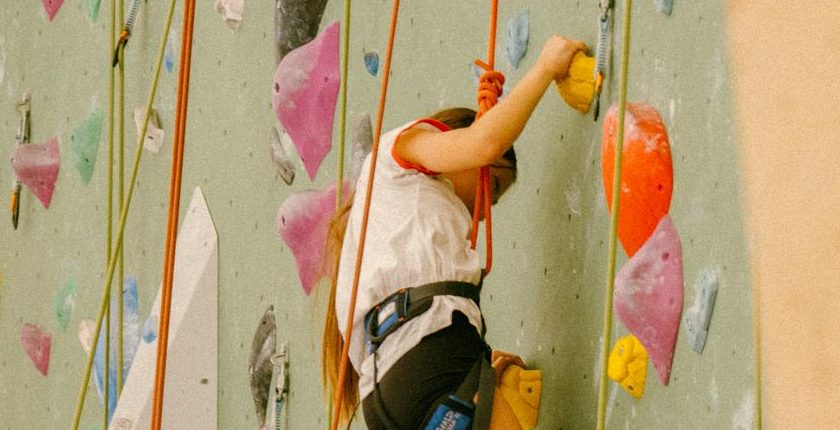 Jeune grimpeuse en progression sur le mur de voies